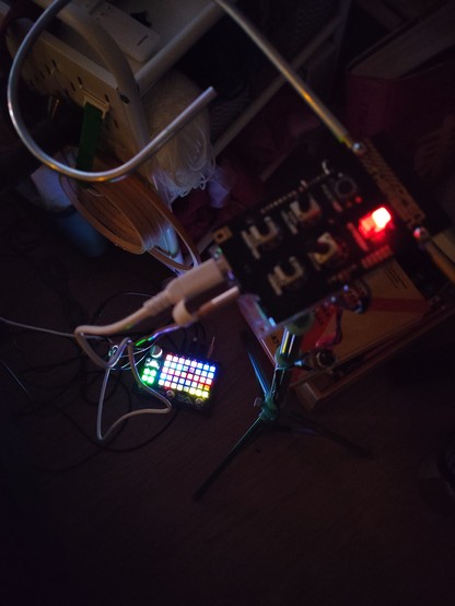 Empress ZOIA on the ground, Open Theremin on a cyan tripod, and lots of craft clutter in the surrounding environment